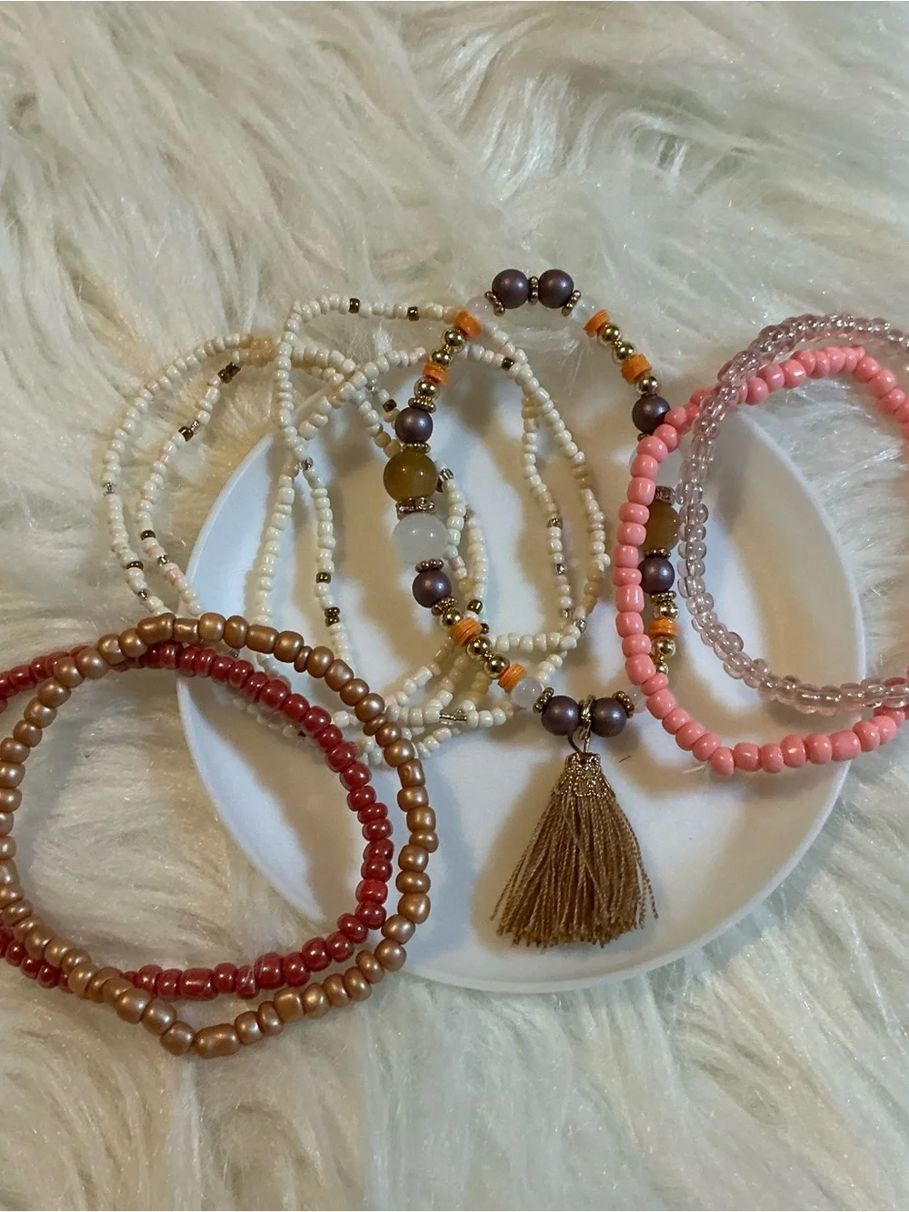 Nine boho pink/beige/gold beaded bracelets